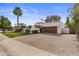 Long driveway and 2 car garage and privacy wall with lush vegetation at 10435 N 98Th St, Scottsdale, AZ 85258