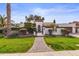 Charming home with lush lawn, privacy wall, tile roof, arched entry, and brick pathway at 10435 N 98Th St, Scottsdale, AZ 85258