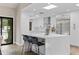 Bright kitchen featuring white cabinets, white countertops, an island, and modern appliances at 10435 N 98Th St, Scottsdale, AZ 85258