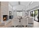 Bright living room features vaulted ceilings, modern fireplace, stylish furniture and sliding barn doors at 10435 N 98Th St, Scottsdale, AZ 85258