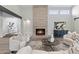 Inviting living room featuring a modern fireplace, comfortable seating, and seamless access to other areas of the home at 10435 N 98Th St, Scottsdale, AZ 85258