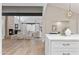 Bright living room featuring a stone fireplace, wood floors, and white sofas creates an inviting gathering space at 10435 N 98Th St, Scottsdale, AZ 85258