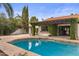 Swimming pool with stone patio, manicured hedges, pergola, and a covered outdoor dining area at 10435 N 98Th St, Scottsdale, AZ 85258
