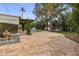 Stunning backyard with a pool, brick patio, fireplace, lounge furniture, and green landscaping at 10435 N 98Th St, Scottsdale, AZ 85258