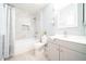 Bright bathroom with tub-shower combo, white vanity, and light blue paint at 10523 W Roundelay Cir, Sun City, AZ 85351