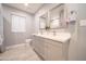 Bathroom featuring double vanity with white countertop, modern cabinets and framed mirrors at 10523 W Roundelay Cir, Sun City, AZ 85351