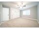 Bedroom features carpet, built-in storage, and a window for plenty of natural light at 10523 W Roundelay Cir, Sun City, AZ 85351
