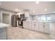 Modern kitchen with quartz countertops, white cabinets and stainless steel appliances at 10523 W Roundelay Cir, Sun City, AZ 85351