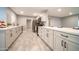 Modern kitchen with quartz countertops, white cabinets and stainless steel appliances at 10523 W Roundelay Cir, Sun City, AZ 85351