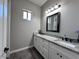 Bright bathroom with double sinks, granite countertops, and modern lighting at 1116 W Stellar Pl, San Tan Valley, AZ 85144