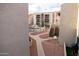 View of the community pool, manicured walkways, and building exteriors from a private balcony at 11666 N 28Th Dr # 298, Phoenix, AZ 85029