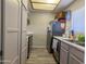Galley kitchen featuring stainless steel appliances and grey cabinets at 11666 N 28Th Dr # 298, Phoenix, AZ 85029