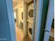 Conveniently located laundry with stacked washer and dryer units adjacent to a well-lit vanity area at 11666 N 28Th Dr # 298, Phoenix, AZ 85029