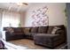 A cozy living room featuring a comfortable sectional couch under a vaulted ceiling at 11666 N 28Th Dr # 298, Phoenix, AZ 85029