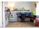 Home office setup with triple monitors, comfortable chair, and decorative shelving creating an inspiring workspace at 11666 N 28Th Dr # 298, Phoenix, AZ 85029