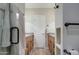 Bathroom featuring dual vanities with granite countertops and tile flooring, with a view to the shower at 11772 E Clinton St, Scottsdale, AZ 85259
