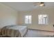 Neutral bedroom with two sunny windows, ceiling fan, and carpeted floor at 11772 E Clinton St, Scottsdale, AZ 85259