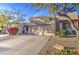 Inviting single-story home with desert landscaping, complemented by a spacious driveway and two-car garage at 11772 E Clinton St, Scottsdale, AZ 85259