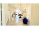 Inviting hallway leads to open-concept dining, living, and kitchen areas in a neutral color palette at 11772 E Clinton St, Scottsdale, AZ 85259
