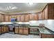 Bright kitchen with stainless steel appliances, granite countertops, and plentiful storage cabinets at 11772 E Clinton St, Scottsdale, AZ 85259