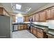 Spacious kitchen with stainless steel appliances, dark granite countertops, and wood cabinetry at 11772 E Clinton St, Scottsdale, AZ 85259