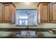 Open kitchen view showcasing granite countertops, stainless steel sink and access to living area at 11772 E Clinton St, Scottsdale, AZ 85259