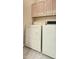 This laundry room features a washer and dryer with cabinets above at 11772 E Clinton St, Scottsdale, AZ 85259