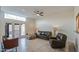 Bright living room with leather furniture, tile floors, and access to outdoor area through glass doors at 11772 E Clinton St, Scottsdale, AZ 85259