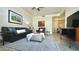 Cozy living room with a leather sofa, comfortable armchair, and stylish patterned rug at 11772 E Clinton St, Scottsdale, AZ 85259