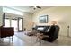 Bright living room boasts a large window, sliding glass door, tile flooring and comfortable furniture at 11772 E Clinton St, Scottsdale, AZ 85259