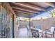 Inviting covered patio featuring a seating area with a brick-lined wall at 11772 E Clinton St, Scottsdale, AZ 85259