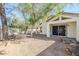 Exterior view of the home with a low maintenance yard, shade trees, and a covered patio at 11840 N 40Th Way, Phoenix, AZ 85028