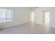 Neutral bedroom with tiled floors, a window, and an adjoining bathroom and closet at 11840 N 40Th Way, Phoenix, AZ 85028