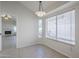 Dining area with tile floors, a modern light fixture, and view to living room with fireplace at 11840 N 40Th Way, Phoenix, AZ 85028