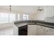 Bright kitchen features stone countertops, white cabinetry, and stainless steel faucet at 11840 N 40Th Way, Phoenix, AZ 85028