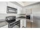 Well-equipped kitchen with stainless steel appliances, stone countertops, and white cabinets at 11840 N 40Th Way, Phoenix, AZ 85028