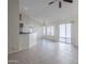 Open living area with tile floors, ceiling fan, and access to the kitchen and outdoor patio at 11840 N 40Th Way, Phoenix, AZ 85028