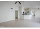 Spacious living area with tile floors, a ceiling fan, and an open view of the modern kitchen at 11840 N 40Th Way, Phoenix, AZ 85028