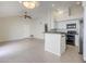 Open floor plan with tile floors connecting the living area to the kitchen with breakfast bar at 11840 N 40Th Way, Phoenix, AZ 85028
