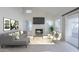 Cozy living room featuring a fireplace, large windows, and access to the outdoors at 11840 N 40Th Way, Phoenix, AZ 85028