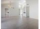 Open-concept living space with tile flooring, high ceilings, two chandeliers, and a built-in cabinet at 11840 N 40Th Way, Phoenix, AZ 85028