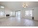 Spacious living room with tiled floors, fireplace, vaulted ceilings, and natural light from multiple windows at 11840 N 40Th Way, Phoenix, AZ 85028