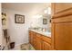 Bathroom features wood cabinets, granite countertops, double sinks, and a large mirror with vanity lighting at 12212 N Paradise Village S Pkwy # 146, Phoenix, AZ 85032