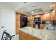 Classic kitchen features stainless steel appliances, granite countertops, and wood cabinetry at 12212 N Paradise Village S Pkwy # 146, Phoenix, AZ 85032