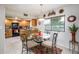 Eat-in kitchen area featuring updated appliances, wood cabinets, and a view of the lush outdoors at 12212 N Paradise Village S Pkwy # 146, Phoenix, AZ 85032