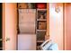 Conveniently located, the laundry area features a stacked washer and dryer unit and shelving for storage at 12212 N Paradise Village S Pkwy # 146, Phoenix, AZ 85032