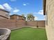 Spacious backyard with brick fencing and verdant artificial turf, great for outdoor activities at 12227 W Prickly Pear Trl, Peoria, AZ 85383