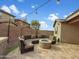 Charming backyard with a cozy fire pit, comfortable seating, and string lights for evening ambiance at 12227 W Prickly Pear Trl, Peoria, AZ 85383