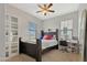 This bedroom features a dark wood bedframe, a desk area, and neutral-colored walls at 12227 W Prickly Pear Trl, Peoria, AZ 85383