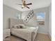 This bedroom features a plush bed with a padded headboard and neutral-colored walls at 12227 W Prickly Pear Trl, Peoria, AZ 85383